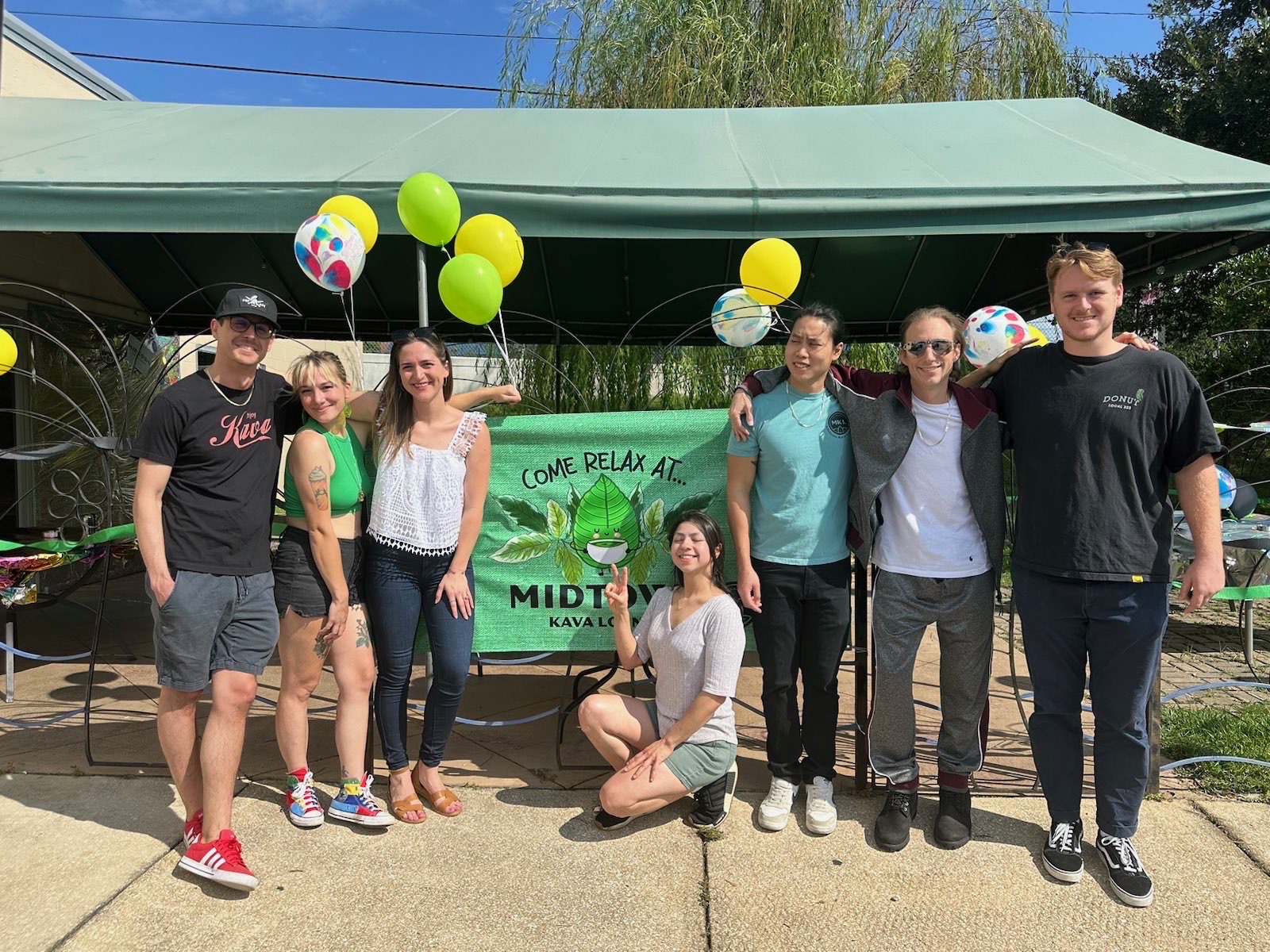 The MKL team out front of the store in front of an MKL 5th anniversary banner