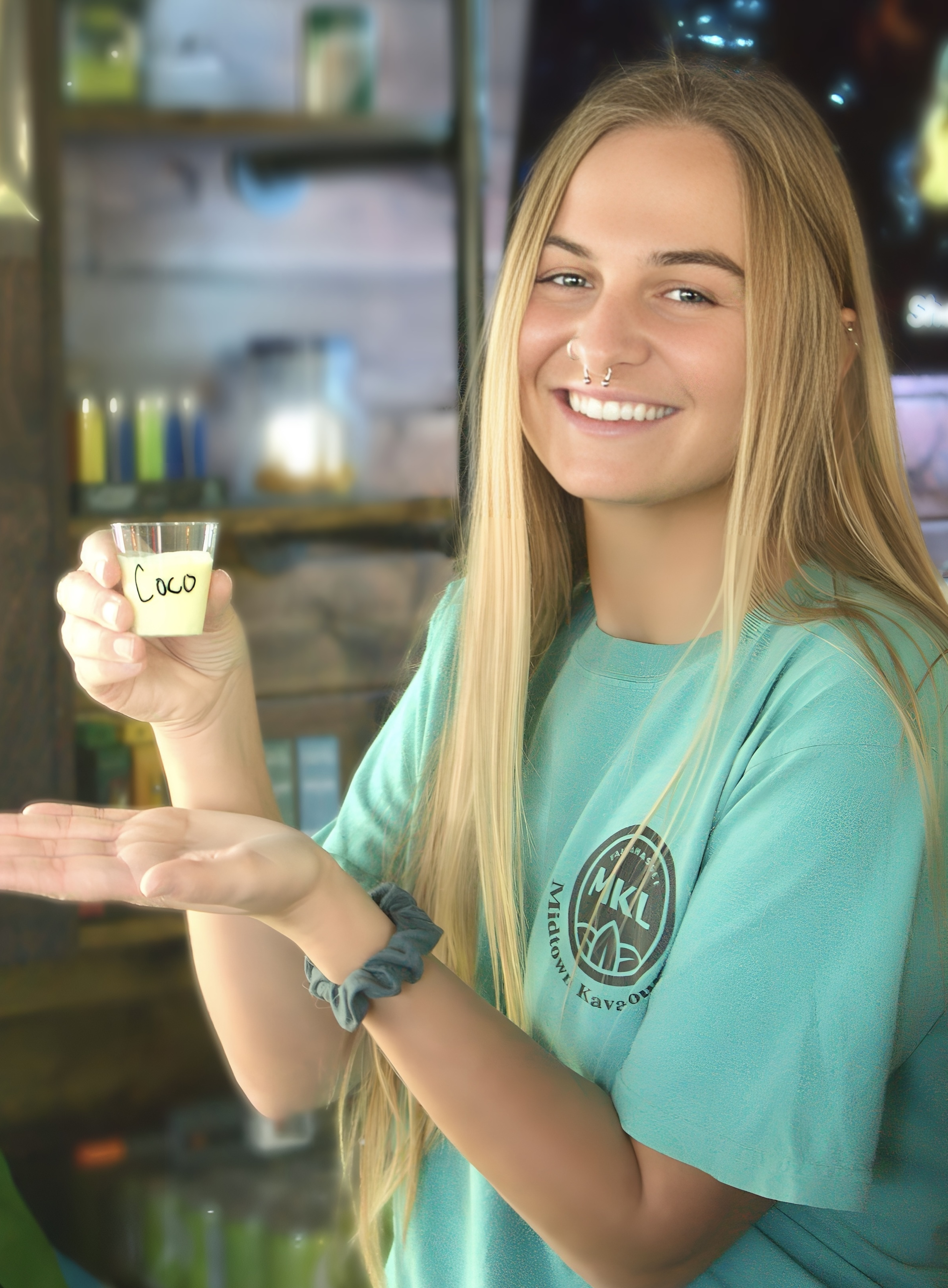 Colby holding a tiki with her name on it