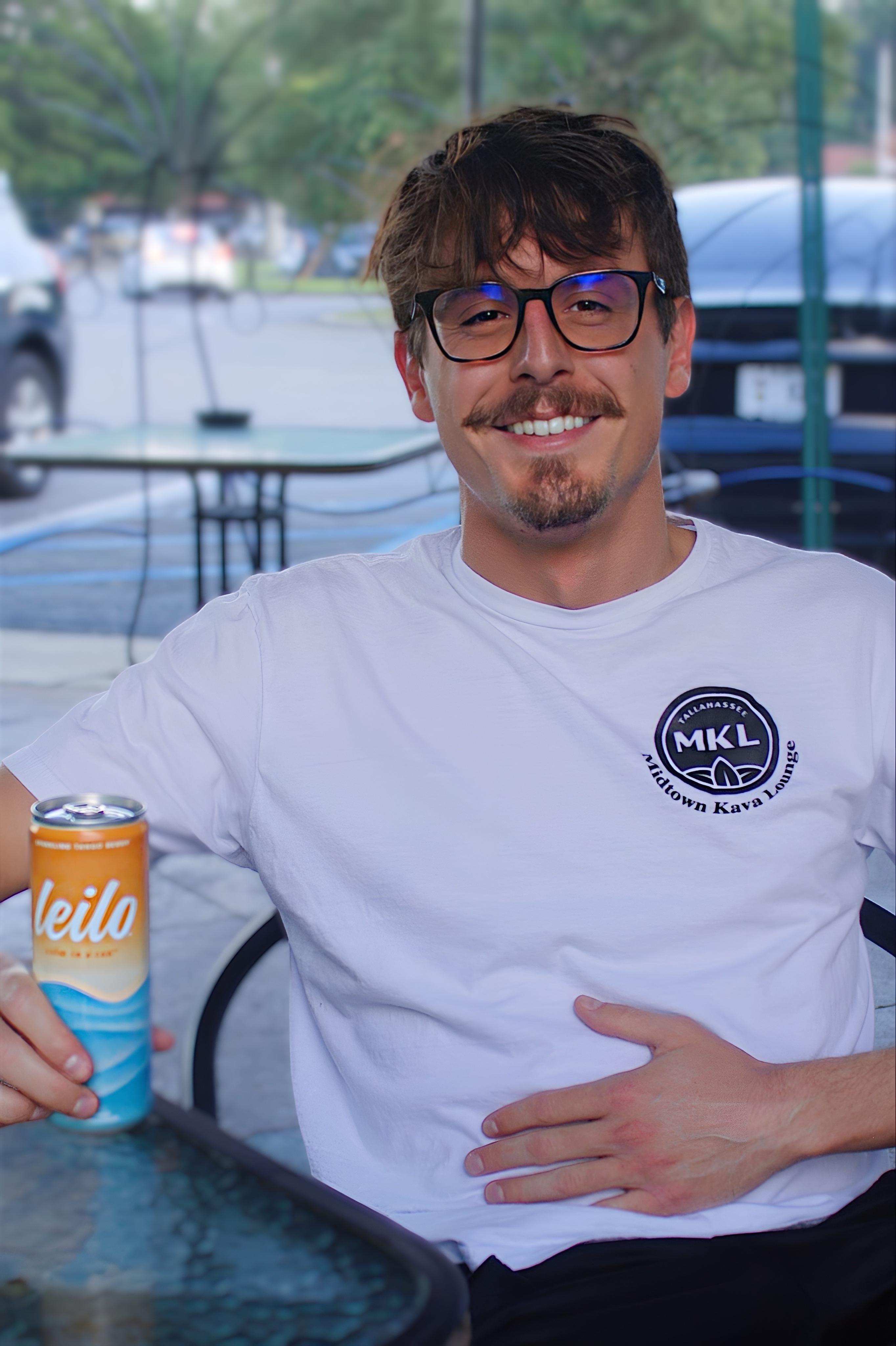 Kyle sitting outside at Midtown Kava Lounge drinking a Leilo